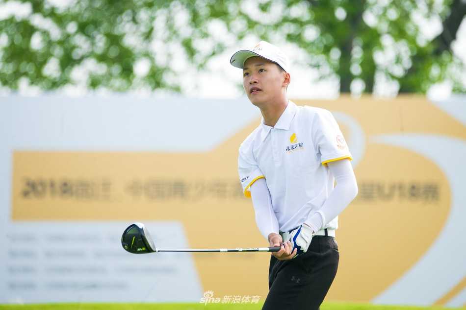 少年球手李里罡在果岭边凝神观察推杆线路，专注的眼神中透露出超越年龄的沉稳与决心