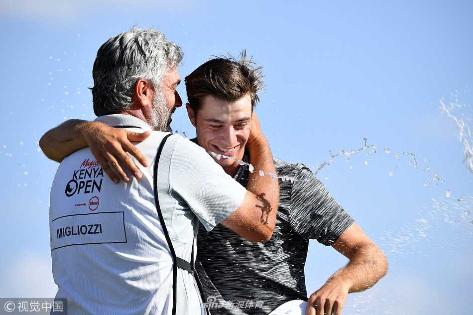 米格里奥兹与亚军球员握手致意，两人相视而笑，体现了高尔夫运动尊重与友谊并重的精神