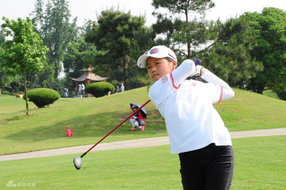 卢钰雯在发球台上自信挥杆，白色小球划破天际，动作流畅充满力量。