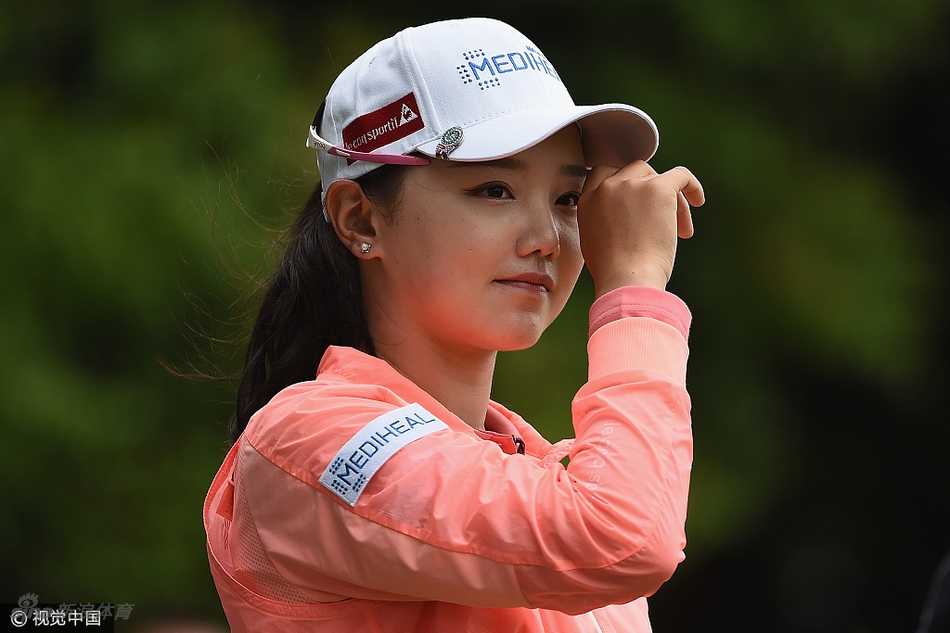 石昱婷在球道上优雅漫步，背景是开阔的比赛球场，展现出高尔夫运动的宁静与力量之美