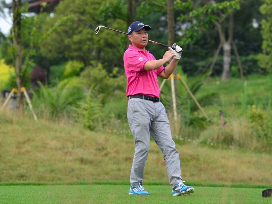 果岭上选手优雅推杆，专注神情与静谧环境融为一体