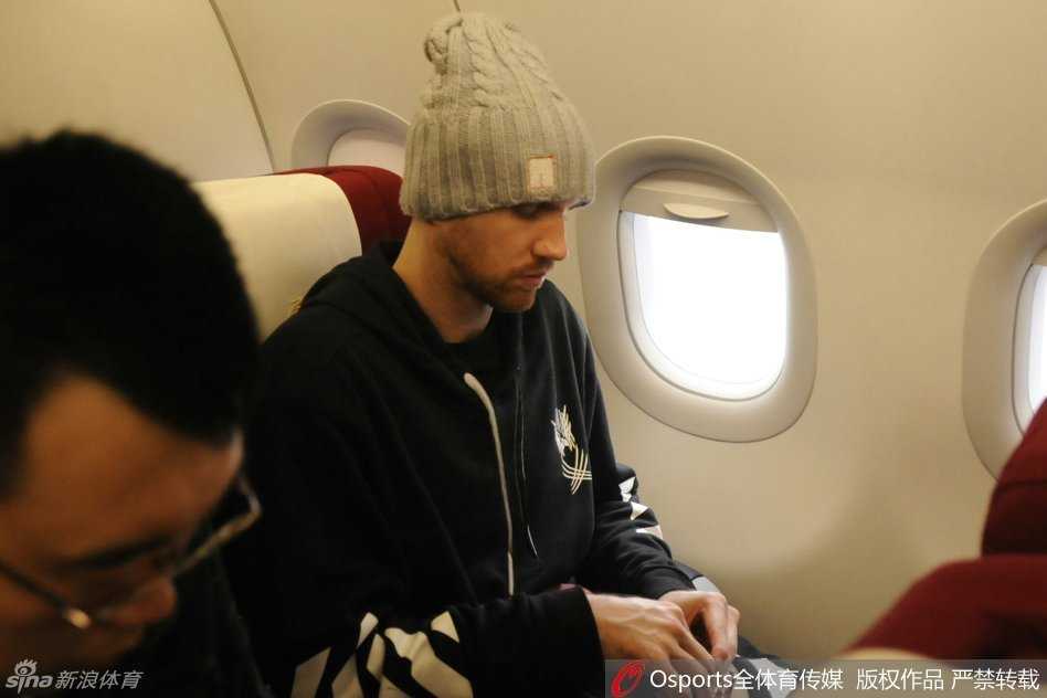 外援兰多夫低头缓步前行，紧锁的眉头和凝重的表情难掩失落，他身旁的队友同样垂头丧气，一行人的背影在机场大厅的光影下显得格外落寞。