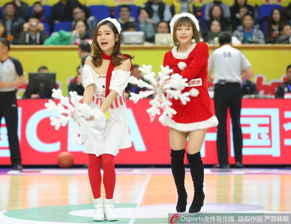 镜头拉近，这位篮球宝贝笑容甜美，正在做一个俏皮的舞蹈动作，露出线条优美的香肩，圣诞氛围中更添几分青春活力。