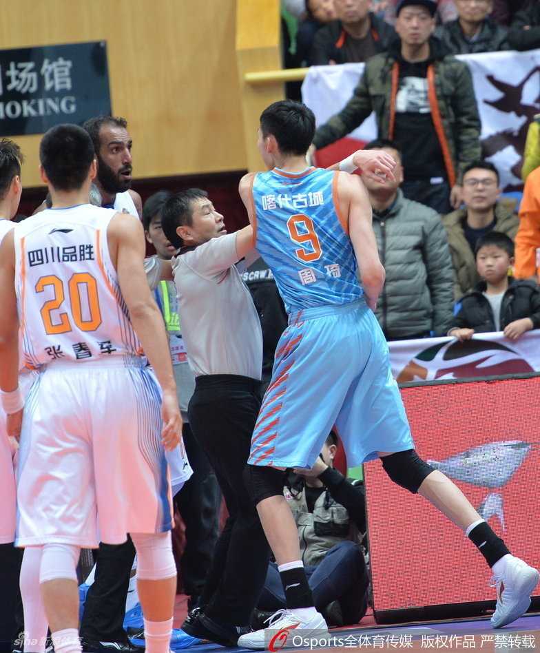 裁判奋力张开双臂，将怒火中烧的周琦与哈达迪隔开，竭力控制混乱的场面。