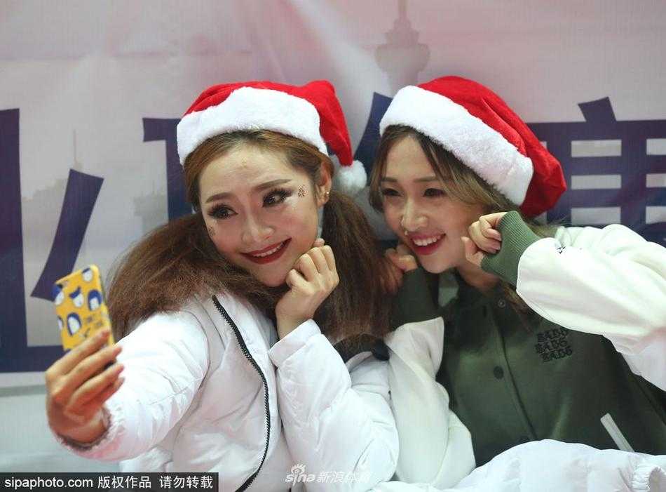 圣诞夜的精灵，八一男篮篮球宝贝身着红色性感圣诞裙装，在赛场边露出甜美的微笑，仿佛将节日的气氛带进了激烈的篮球战场。