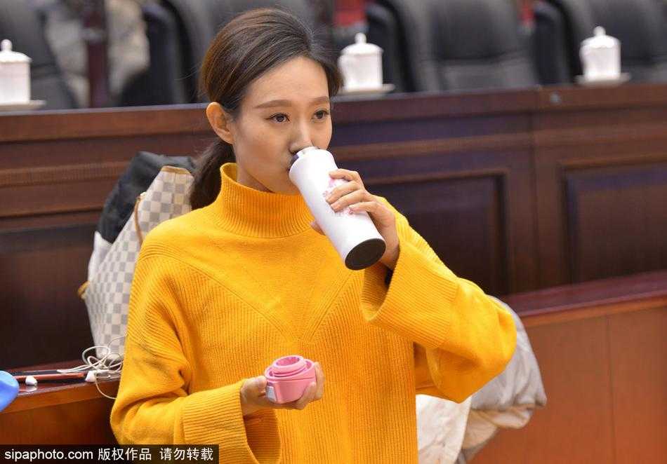 比赛进入白热化，美女记者身姿挺拔地站在场边文字席前，一手持笔记本一手握笔，趁着死球间隙飞速记录着战术变化。即便在激烈的竞技氛围中，她依然保持着职业女性的优雅与干练。