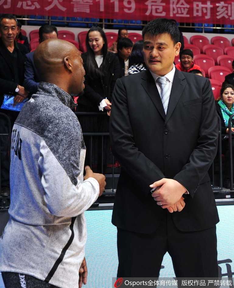 时光荏苒情谊未改:姚明与兰德里赛场叙旧 兰德里面带微笑,神情专注地倾听姚明说话,姚明则伸手比划着,两人之间的互动自然又默契,老友相见分外亲切。