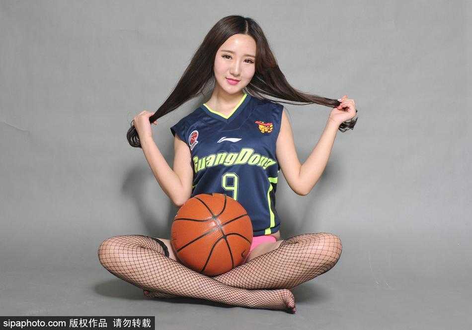 易建联九号战袍传承,篮球宝贝黑丝美腿助威宏远 镜头聚焦在宝贝纤细的脚踝和脚下的篮球鞋上,黑色的丝袜在球场灯光下泛着微光,她身体微曲,双手指尖比出爱心,将赛场边的铁马变成了展示美丽的舞台。