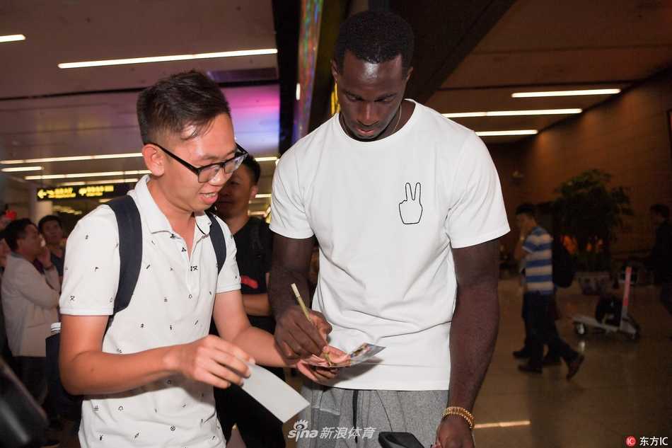 面对球迷们突如其来的热情“围攻”，巴斯显然受宠若惊，他露出标志性的憨厚笑容，一一满足了大家的签名与合影请求。