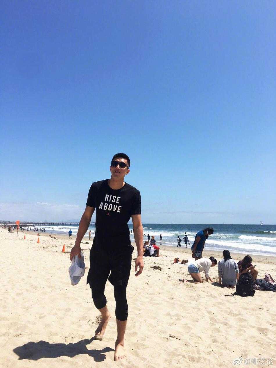 郭艾伦的洛杉矶海岸日记:阳光沙滩烤苞米,还有那一双大长腿 比赛结束后,郭艾伦站在一群街球手和中国球员中间,他咧着嘴笑得毫无防备,两只手随意地搭在队友肩上,背景是洛杉矶特有的棕榈树和涂鸦墙,记录下了那个纯粹的快乐瞬间